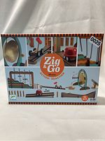 Front of boxed Zig & Go Music game showing brand, number of pieces (52), and target age (8-99).