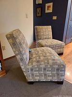 Side angle view showing two slipper chairs with taupe and brown geometric upholstery fabric placed next to each other in room interior