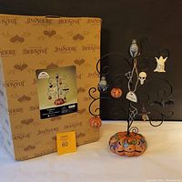 Jim Shore Halloween tree displayed next to original branded box showing packaging and item branding.