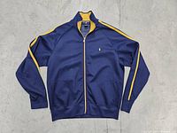 Front view of vintage Polo Sport zip-up jacket hanging with full front zipper and yellow piping details.