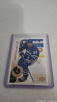 Clear image of Auston Matthews hockey trading card in Toronto Maple Leafs uniform with number 34, in protective sleeve