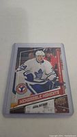 Front of Auston Matthews rookie hockey card in plastic sleeve showing player in Toronto Maple Leafs uniform with 'Memorable Moments' banner and Upper Deck branding.