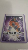 Front view of Connor McDavid hockey card with purple energetic lightning background and 'ENERGY' text