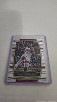 Front view of Scottie Barnes rookie basketball card in protective sleeve showing player action image and design detail.