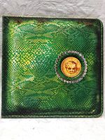 Front side of green snake skin patterned gatefold album cover with gold coin decoration