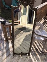 Full-length view of rectangular mirror showing gilded carved frame and overall condition