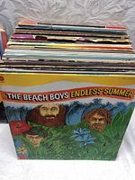 Photo of a stack of vinyl records with The Beach Boys Endless Summer album cover visible.