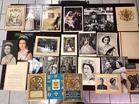 Full overview of the lot showing various royal memorabilia items arranged on the floor, including photos, magazines, and booklets.