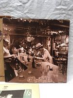 Front view of album cover showing bar scene with people at counter and neon 'Coors' sign.