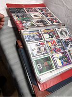 Full view of two binders open showing hockey cards of various NHL players, including goalie and action shots.