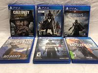 Front view of all six PS4 game cases arranged in two rows, showing cover art and titles.