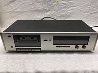 Front view of LUXMAN K-205 cassette deck showing cassette slots, control buttons and headphone jack.