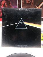 Photo of the Pink Floyd Dark Side Of The Moon album front cover with iconic prism artwork.