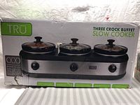 Box showing full view of TRU three crock buffet slow cooker with three crock inserts and brand/label info.