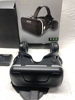 ETVR VR headset with head strap and headphones visible in front of its retail box.
