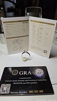 Ring and GRA certificate card displayed, front view