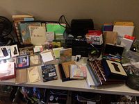 Wide view of table showing printer, journals, folders, sticky notes, pens, and various office supplies