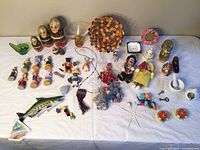 Full overview of all miniatures including nesting dolls, sock dolls, tassels, small figurines, and button basket