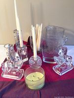 Photo of the glass horse bookends, candle holders, and glass pitcher showing the lot contents.