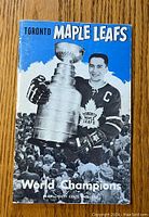 Front cover of media guide showing Toronto Maple Leafs player holding the Stanley Cup and text 'World Champions'