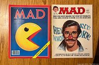Front covers of MAD Magazines #187 (Pac-Man cover) and #233 (Alfred E. Neuman cover)