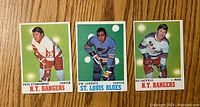 Front of three 1970-71 O-Pee-Chee hockey cards showing Pete Stemkowski, Jim Lorentz, and Vic Hadfield, with color photos on green backgrounds.