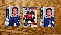 Front view of three Mitch Marner hockey cards: two Toronto Maple Leafs cards and one Team Canada card.