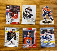 Top side view of six Connor McDavid hockey cards showing front designs and various poses.