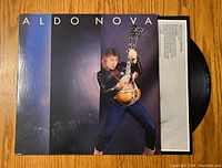 Front cover of Aldo Nova vinyl record showing artist with guitar and title.