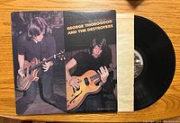 Front of the George Thorogood & The Destroyers vinyl record album cover with photo of band members playing guitar.