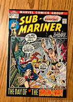Front cover of Sub-Mariner #53 comic showing main characters in action and title.