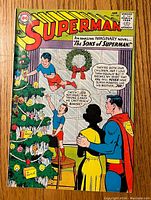 Front cover of Superman #166 comic showing Christmas-themed illustration with Superman and children decorating a tree