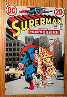 Front cover of a vintage Superman comic book issue #263 featuring Superman with molten flame effect in an urban environment and 20 cent price.