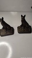 Pair of 1930s Art Deco German Shepherd cast iron bookends showing both pieces side by side.