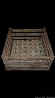 Wooden egg crate with cardboard egg tray inside shown against black background.
