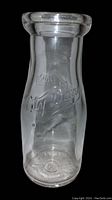 Clear glass milk bottle, half pint size, embossed with 'City Dairy' logo on the body.
