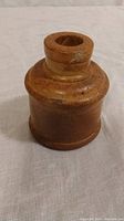 Front angle view of early Canadian redware pottery inkwell showing the round form and mouth opening.