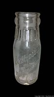 Clear glass half pint milk bottle with embossed lettering 'Silvercraft, Inc. Milwaukee'.