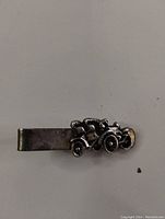 Silvertone Model T car tie clip showing detailed vintage car design attached to tie clip base.
