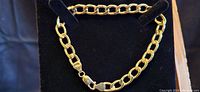9-inch yellow gold chain link bracelet displayed on black velvet