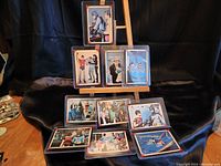 Set of 10 Batman 1966 Riddler trading cards displayed on a stand, showing a variety of colorful scenes and characters from the show.