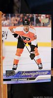 Front side of Adam Ginning Young Guns rookie card showing player in Flyers uniform with 'Young Guns' branding.