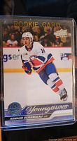 Front of Arnaud Durandeau Young Guns rookie card showing player in Islanders uniform skating on ice with Rookie Card and Young Guns branding.