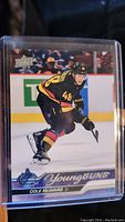 Front of the Cole McWard Young Guns rookie hockey card in protective sleeve showing him skating in Vancouver Canucks uniform with Young Guns branding.