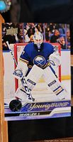 Front of the Devon Levi Young Guns rookie card showing action photo of the player in Buffalo Sabres uniform and goalie equipment.