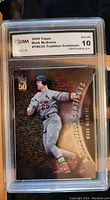 Front of baseball card showing Mark McGwire in batting stance wearing St. Louis Cardinals uniform with label and grade of 10 by GMA