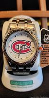 Front view of new Montreal Canadiens men's watch with stainless steel band, round analog dial, and team logo.