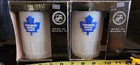 Two boxed Toronto Maple Leafs beer mugs with NHL logos on packaging and mugs visible through window.