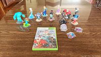 Wide shot showing game disc and all included Disney Infinity figures and power discs on a wooden table.