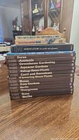 Stack of gardening books including Time Life Encyclopedia of Gardening series and additional gardening books; titles visible from spine